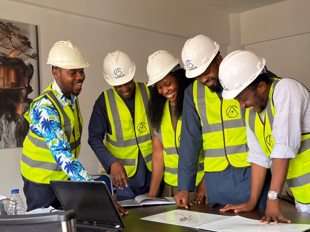 A team of African engineers reviewing construction plans